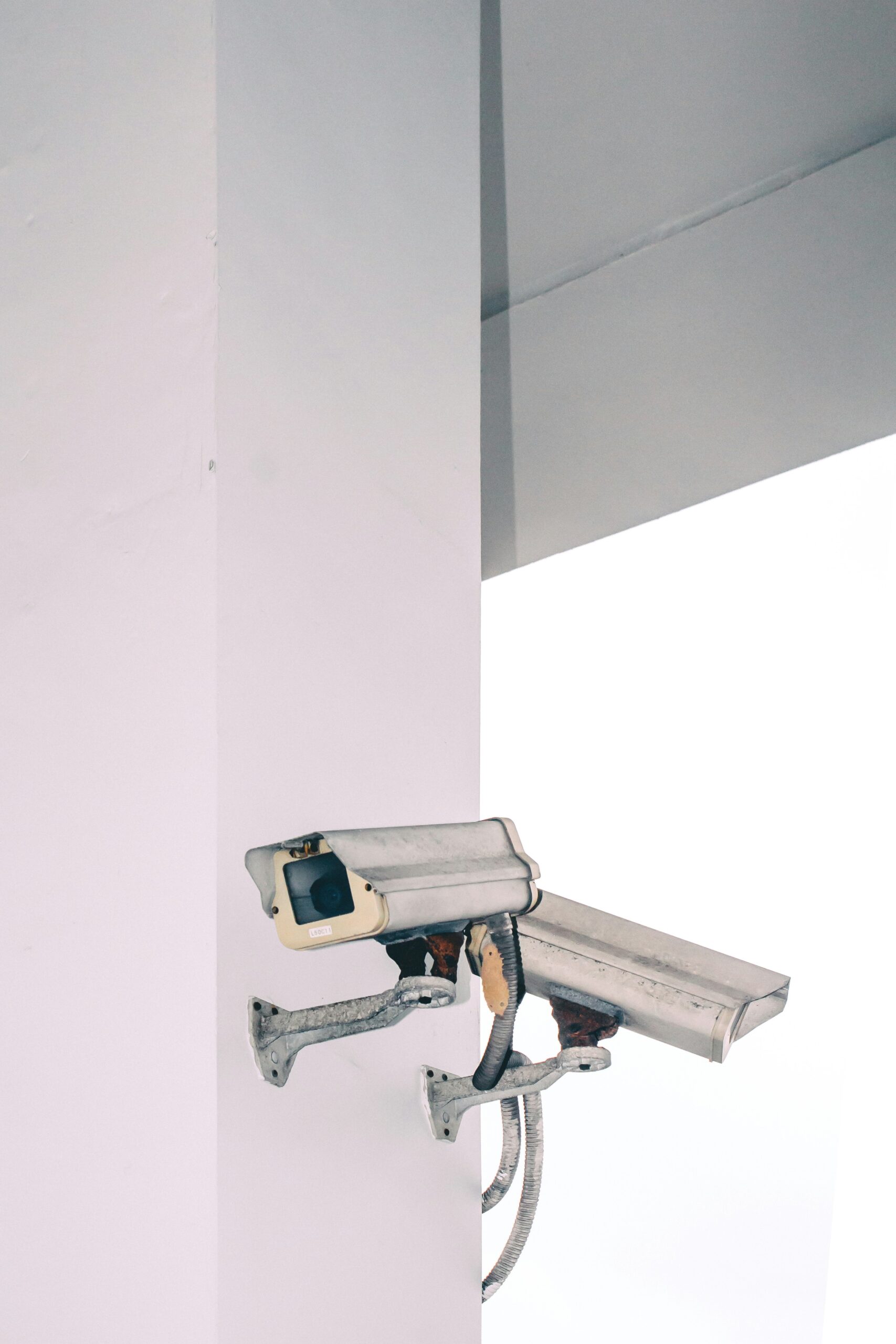 two bullet security camera attached on wall